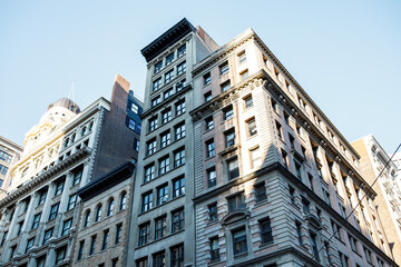 Fototapeta premium New York street pedestrian direction sign. Street name signs in Manhattan. Building sign. New York streets. Empty streets. New York buildings. Old architecture buildings in Manhattan. Home facades. 