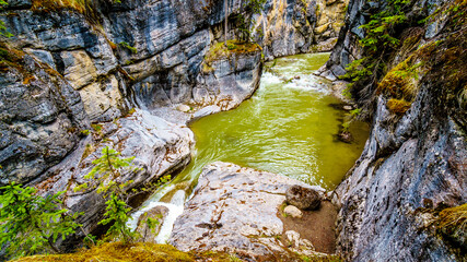 The turbulent waters of the Maligne Canyon flowing through the deep Maligne Canyon in Jasper...
