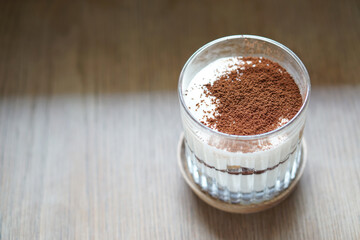 Homemade Tramisu cake in a glass on wooden table, Traditional Italian dessert.