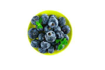Fresh large ripe blueberry in a plate. Isolated on a white background, top view