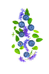 Fresh large ripe blueberry with purple wildflowers and green leaves. Isolated on a white background, top view.Summer flower pattern