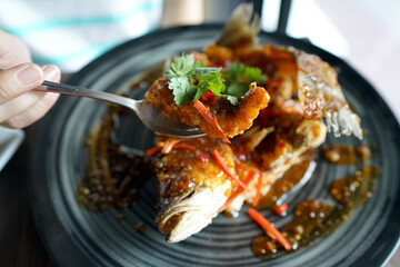 Deep fried Sea bass with sweet and sour sauce, Traditional Thai food recipe.