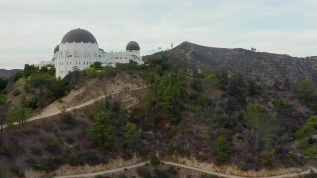 AERIAL: Griffith Observatory with Flight over Hollywood Hills on Cloudy Overcast Day in Los Angeles