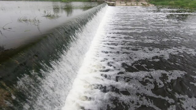 Fish Leaping River Weir On Upstream Migration. Slow Motion Footage