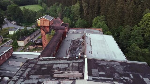 Devastating aerial view of a lost place socialist factory in former GDR in the middle of a forest