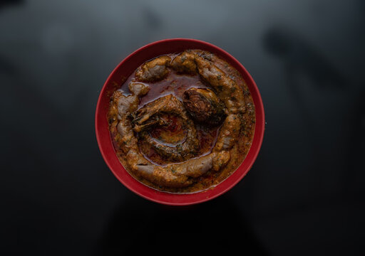 A bowl of amala with ewedu and gbegiri sauce with stewed fried mackarel and eja kika