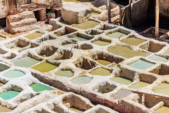 Tannery tanks in Fes, Morocco, filled with tanning solution for leather
