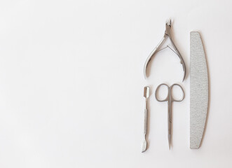  manicure set on a white background: scissors, pusher, nail file, tongs. professional pedicure tool.