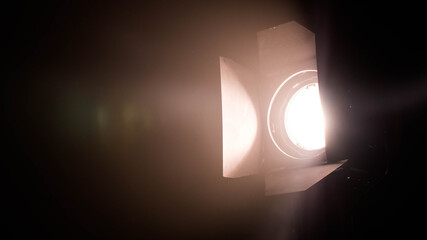 Fototapeta na wymiar Light movie lamp on tripod color low light