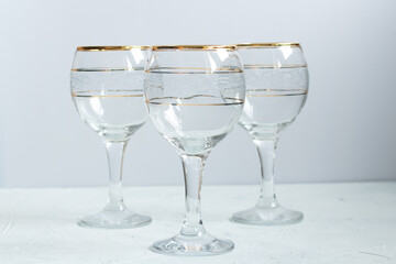 Crystal glasses with gold patterns. Selective focus