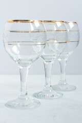 Crystal glasses with gold patterns. Selective focus