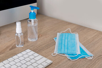 Alcohol Gel Hand Sanitizer and Medical Mask in a office