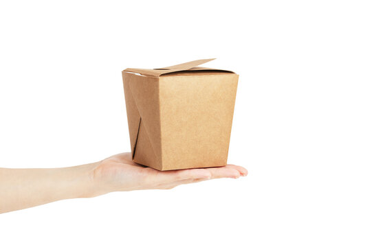 Empty square cardboard box made of kraft material on hand on isolate white background. Copy space, mock up, side view. Fast food delivery in the grocery box.