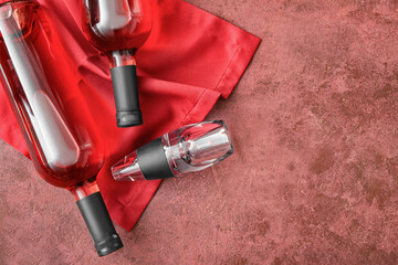 Aerator with bottles of wine on color background