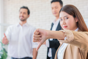 business woman thumbs down but Business team group with thumbs up in modern office