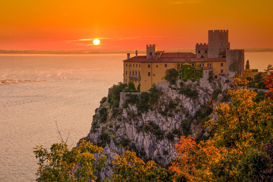 Amazing sunset over Mediterranean Duino Castle. Italy.