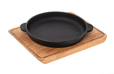 black pan without a handle on a wooden kitchen board on a white background