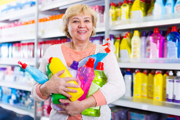 Laughing woman choosing household chemical goods