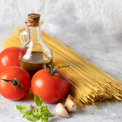 Dry Spaghetti bunch, fresh tomatoes, basil, garlic and olive oil.Principal igridients for Italian dish Spaghetti Al Pomodoro