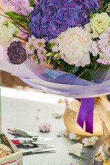 Flower bouquet with purple hydrangea. Stylish bouquet as a gift. Small business. Flower sales. Selective focus.