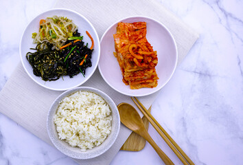 Korean food with rice, kimchi, side dishes.