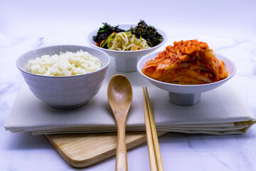 Korean food with rice, kimchi, side dishes.
