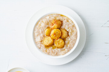 Whole oatmeal, large bowl of porridge with caramelized banana for breakfast
