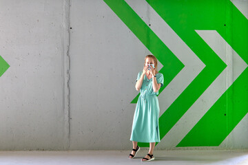 Fototapeta premium Caucasian blond woman wearing a face mask for protect during coronavirus Covid-19 epidemic on the parking of shopping mall. Coronavirus Covid-19 concept.