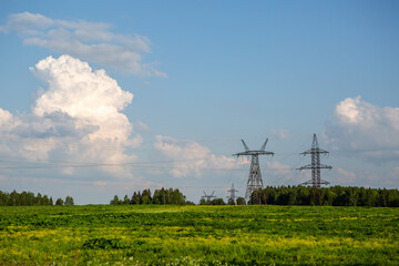Fototapeta na wymiar Poles of power lines in the field
