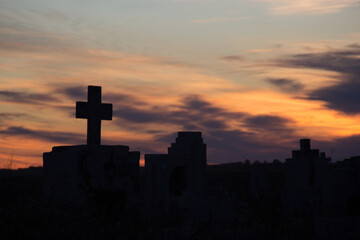 cross tomb cemetery silhouette at sunset