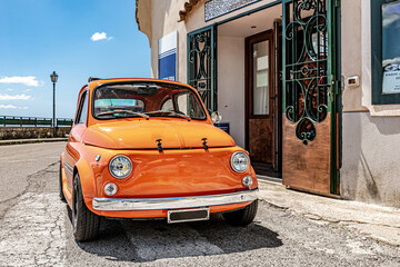 Amalfi, Coast, Italy. May 27th, 2020. An old style retro Fiat 500, parked along the road to Positano. - obrazy, fototapety, plakaty