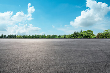 Empty asphalt road and green forest under blue sky. © ABCDstock