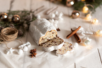 Obraz na płótnie Canvas Christmas stollen on wooden background. Traditional Christmas festive pastry dessert. Stollen for Christmas.