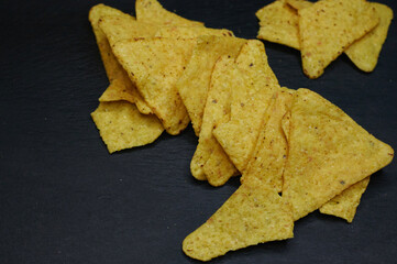 nachos on a black background filmed horizontally