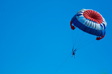 red white blue parachute attraction isolated on blue