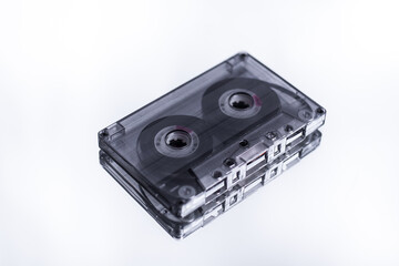 Obraz premium old audio tape on a white background with a reflection in the mirror