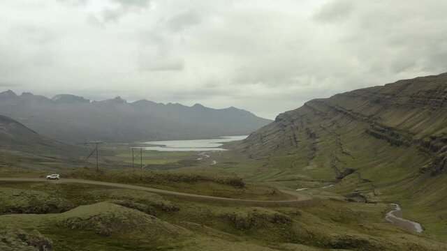 Berufj&ouml;r&eth;ur Fjord, &Ouml;xi Road, Mountains, Valley, River, Car Passing By, Iceland, Flying To The Right (Camera Movement)