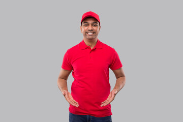 Delivery man Holding Empty Open Hands in front of Chest Isolated. Indian Delivery boy Advertisment Concept