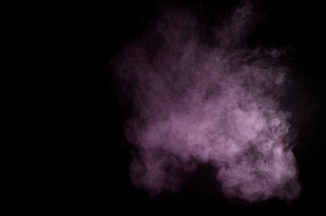 Purple powder explosion on black background. Colored powder cloud. Colorful dust explode. Paint Holi.