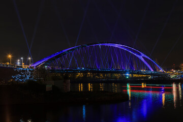 Fototapeta na wymiar Night picture of East harbor bridge in Frankfurt during lighting show Luminale 2014 in April