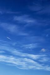 Cirrus clouds against a blue sky view from below