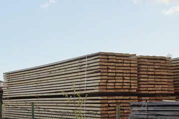 Pallet storage of wood in the company in the industrial zone of the city on a spring day