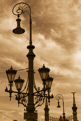 Widok w sepii na starą industrialną latarnię uliczną w Budapeszcie na tle zachmurzonego nieba © Sebastian Gacki