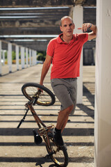 Bmx rider performing tricks and talking  on the smartphone