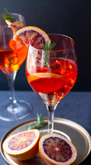 Blood orange cocktail drink or aperol spritz and slices of orange
