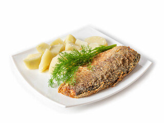 Side view of a carcass of fried breading fish on a plate with boiled potatoes and a sprig of fresh dill