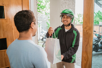 man delivery service uber send shopping bag to customer at home