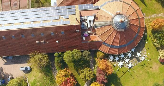 Bird-eye aerial over a building with solar panels