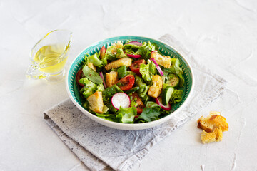Middle Eastern salad Fattoush with green vegetables, tomatoes, radishes and toasted pita bread. Lebanese cuisine