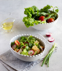 Fattoush salad, Middle Eastern cuisine. Lettuce, herbs, tomato, cucumber, radish and pieces of toasted pita bread. Bowl with fresh vegetables